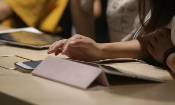 Student typing on a tablet