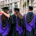 Five LSE graduates photographed from behind showing their caps and gowns