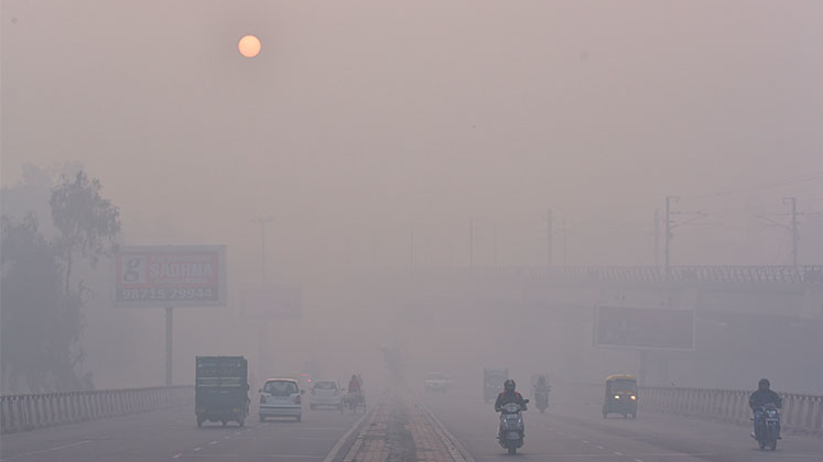 A motorway in Delhi obscured by smog