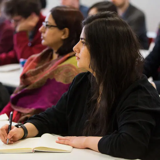 People in a seminar taking notes