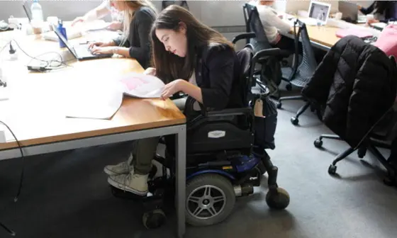 A student working at desks in the library