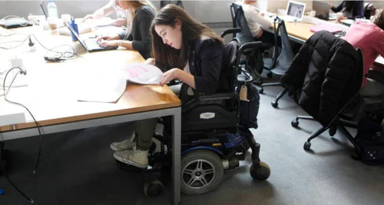 A student working at desks in the library
