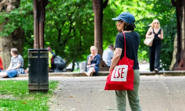 An LSE student standing in a park