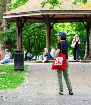 An LSE student standing in a park