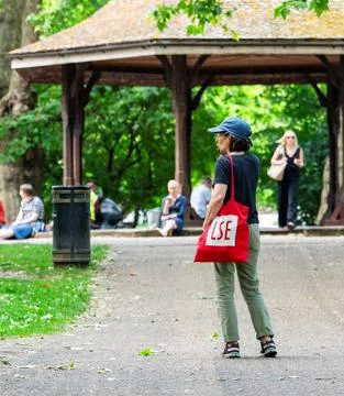An LSE student standing in a park