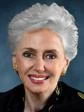 The image is of Georgette Bennett, an academic with white hair and gold earrings.