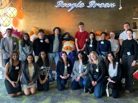 A group of students pose together on a trip to the Google offices