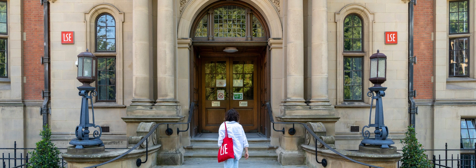 A person with an LSE tote bag outside the Sir Arthur Lewis Building, home of economics at LSE