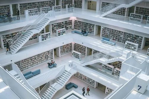 White library with books and staircases