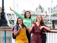 three students smiling