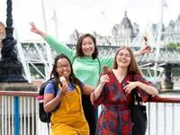 three students smiling