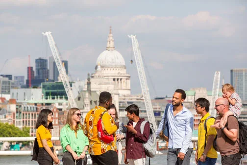 LSE students at the South Bank in London with the Thames and St Paul's Cathedral in the background.