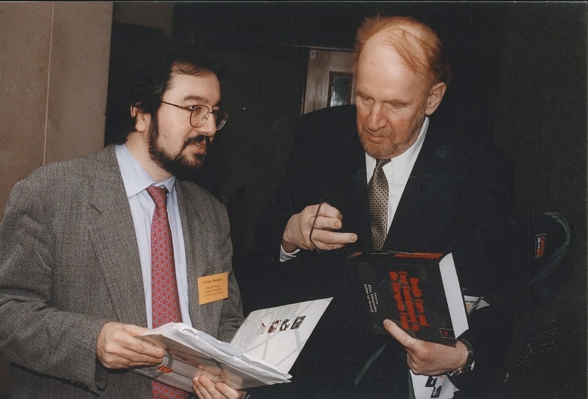Elias Mossialos gifting a book to Professor Egon Jonsson, then CEo of the Swedish Agency for Health Technology Assessment and Assessment of Social Services (SBU)