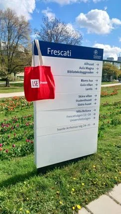 A photo of an LSE Press tote bag hanging on a campus sign at SSE.