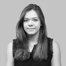 A black and white image of Emily Tadgell. She is looking at the camera and smiling.