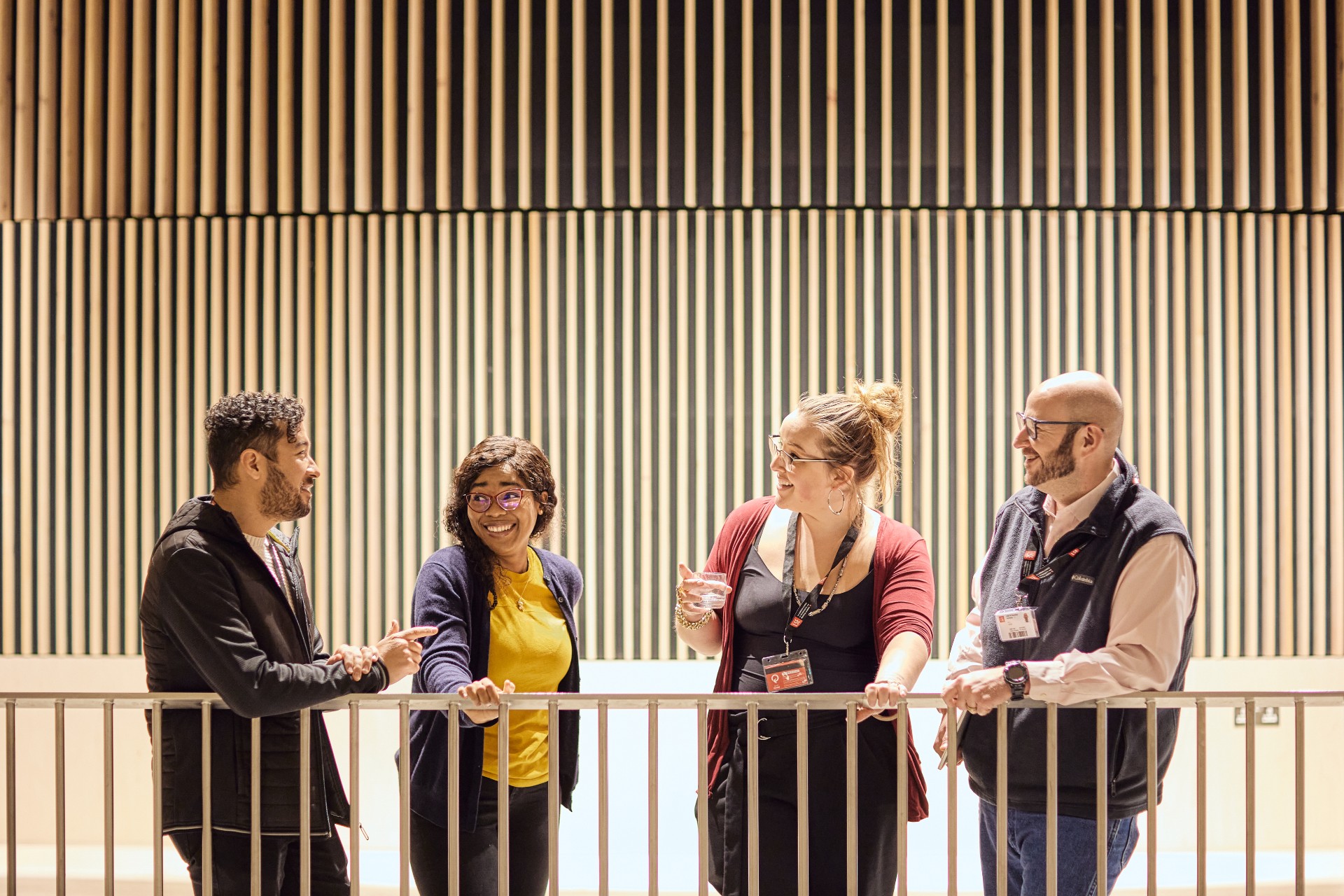 A diverse group of four EMSBE students networking outside the lecture theatre