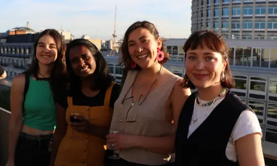 A group of students smiling on LSE rooftop