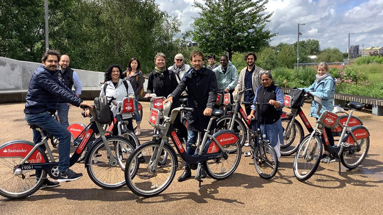 a group of people on Santander bicycles in the London Olympic Park at Stratford