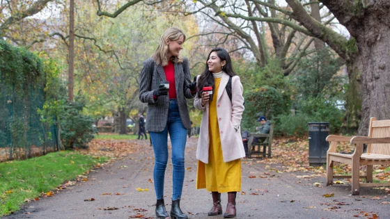 Two girls walking with coffee