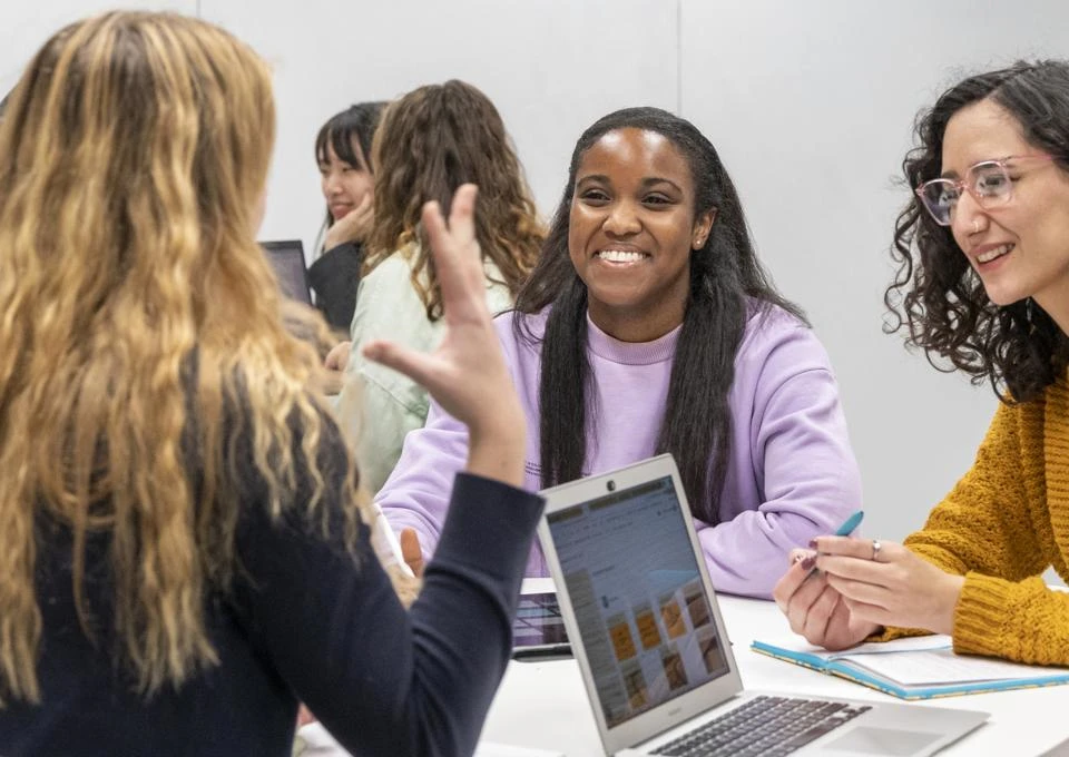 Students chatting and smiling in a classroom