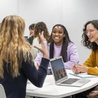 Students chatting and smiling in a classroom