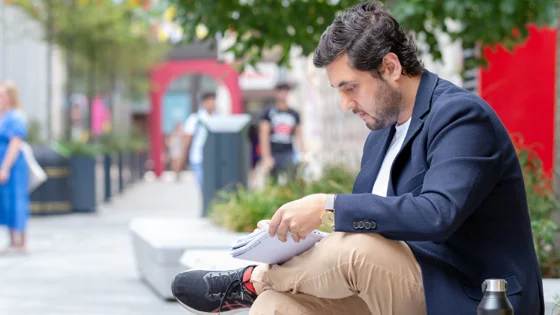 Student sitting with a notebook
