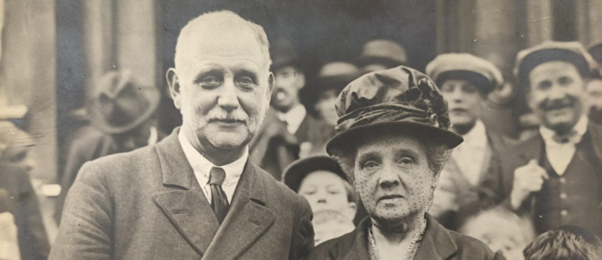 Two people stood photographed amongst a crowd