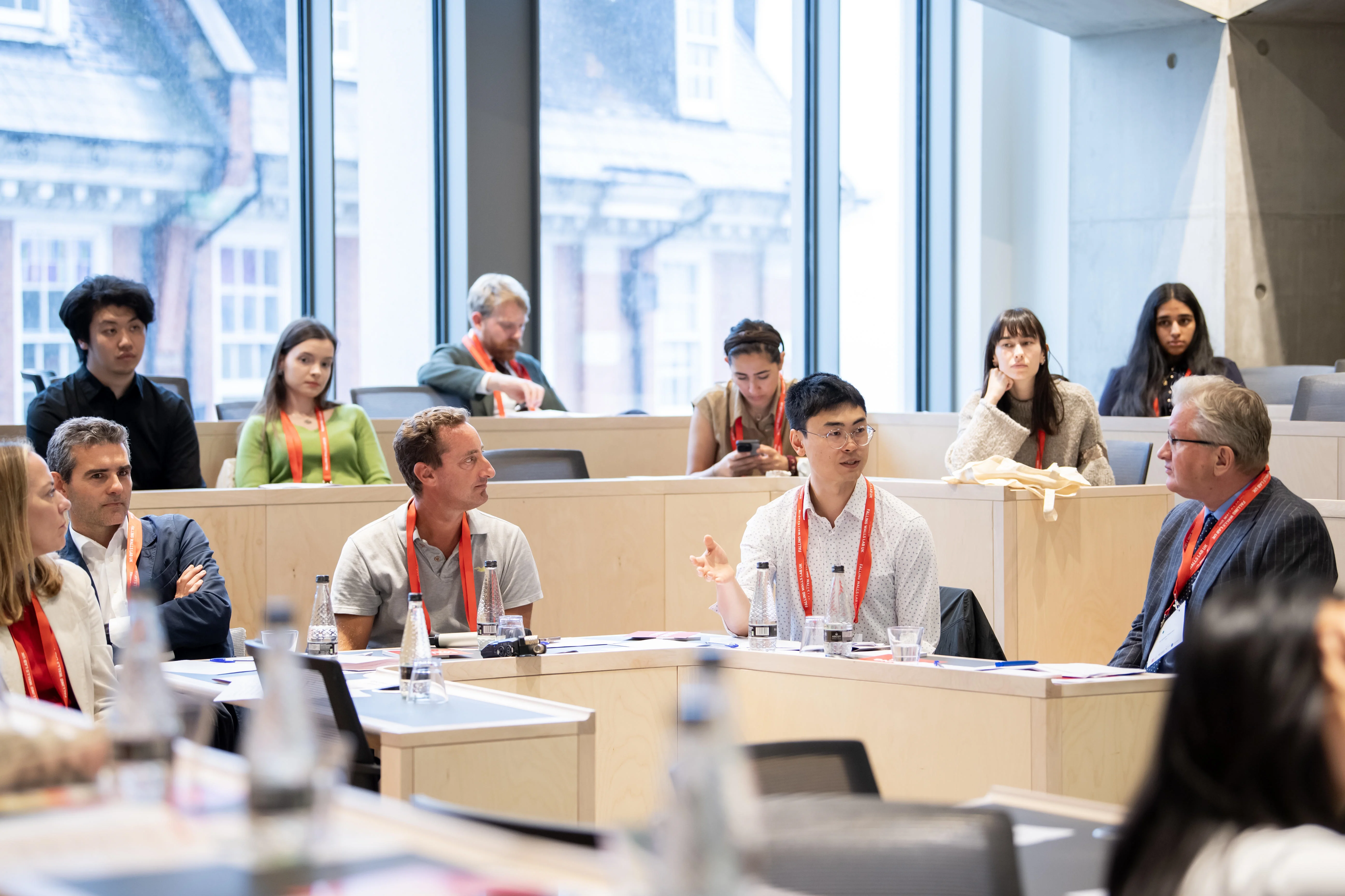 The judges of the Falling Walls lab sitting at a table during the competition, discussing a pitch.
