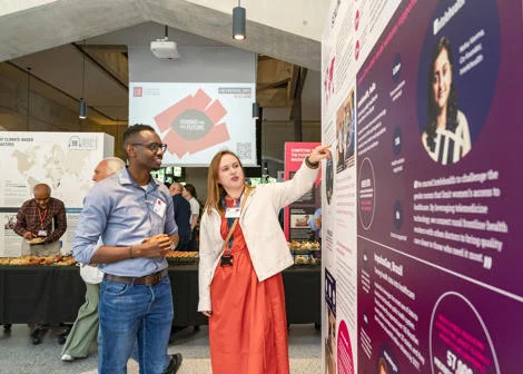 A researcher shows an exhibition visitor her research
