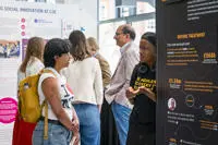 Students talking at exhibition