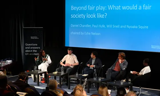 An slide titled "Beyond fair play: what would a fair society look like" with a panel sitting in front.