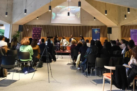 Audience picture looking at a panel of speakers
