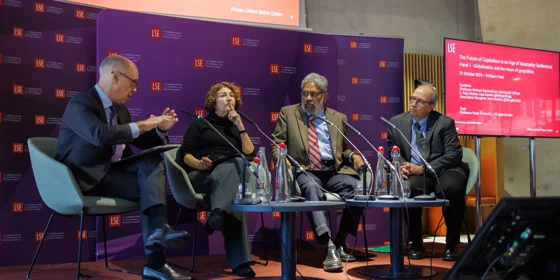 Panel of four speakers at a conference