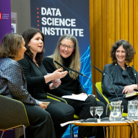 Panellists sit and laugh together