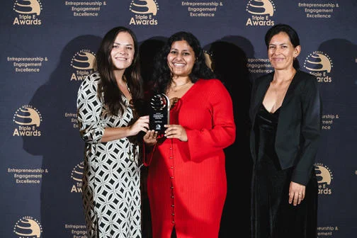 The LSE Generate team smile are the camera at Triple E awards