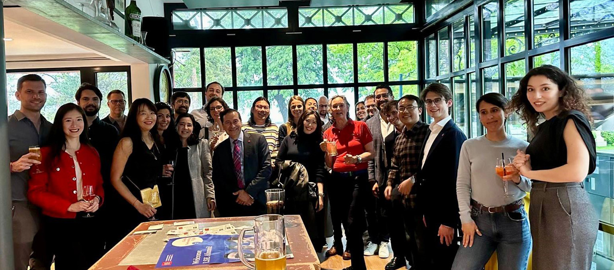Alumni in Geneva gather for a photo during an event.