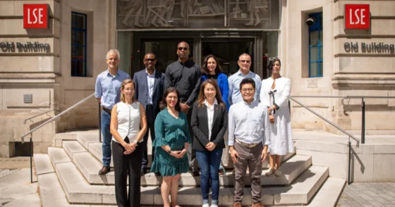 Ten members of Global Alumni Board standing on steps smiling.