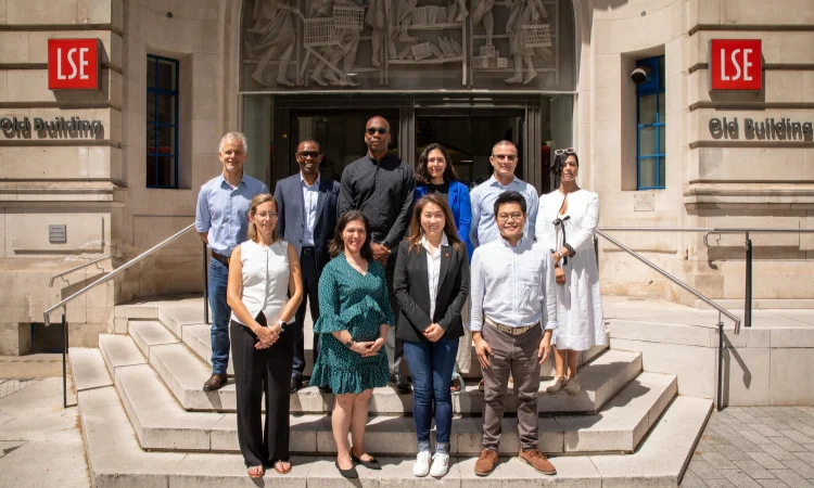 10 members of the Global Alumni Board on steps of Old Building