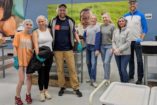 Alumni volunteers pose a photo following a day of volunteering with a food poverty charity