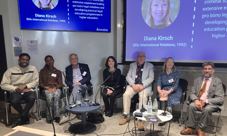 Six alumni seated around Professor Mick Cox