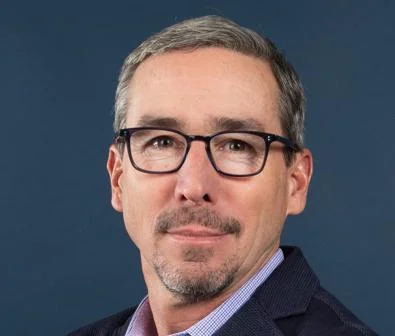 Gordon Hanson in front of a blue background.