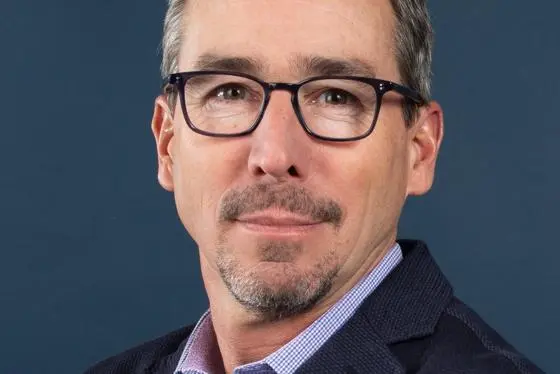 Gordon Hanson in front of a blue background.