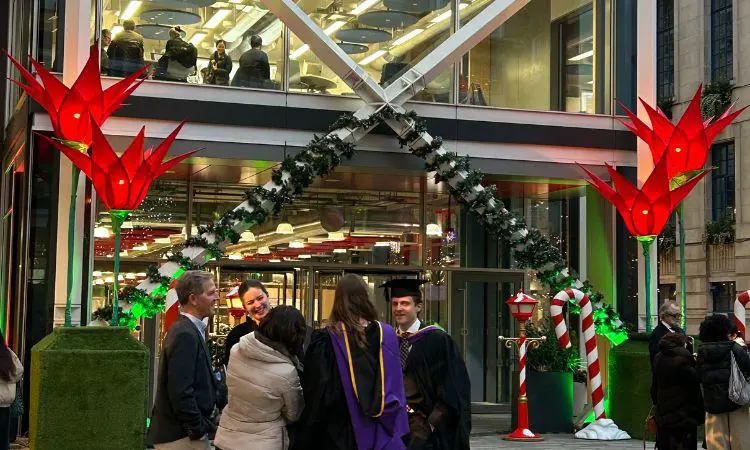 Graduates in front of Centre Building with Christmas decorations in the background