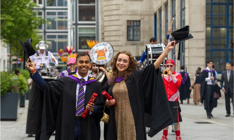 Graduates celebrating following their ceremony on campus.