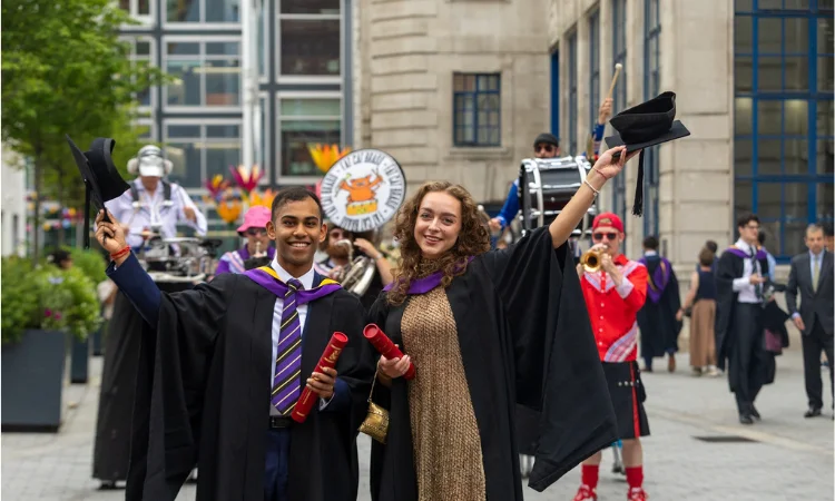 Graduates celebrating following their ceremony on campus.