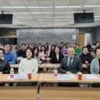 Audience attending a formal seminar or lecture in a conference room setting