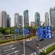 Modern city skyline with tall skyscrapers overlooking a busy multi-lane urban road