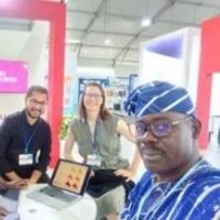 Four researchers at an indoor exhibition booth in a bright event space