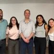 Group of academics posing together indoors in an office or classroom setting at the partner university in Mexico