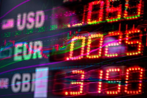 Electronic financial ticker board showing USD EUR  and GBP with red and green LED numbers and overlaid line graphs